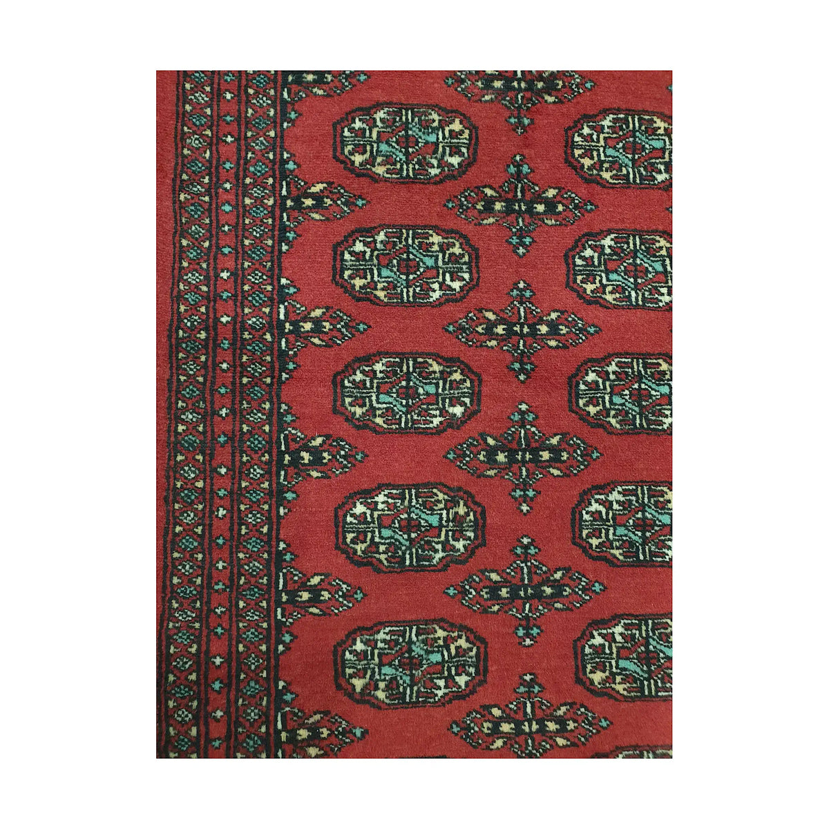 Pattern detail of Afghan Bokhara runner rug showing repeated gul medallions, red field and multicolour border