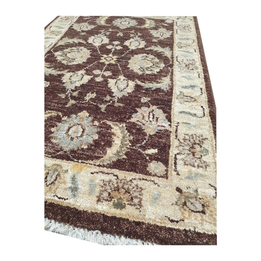 Border corner detail of Afghan Chobi dark brown medallion rug showing wool pile and beige pattern