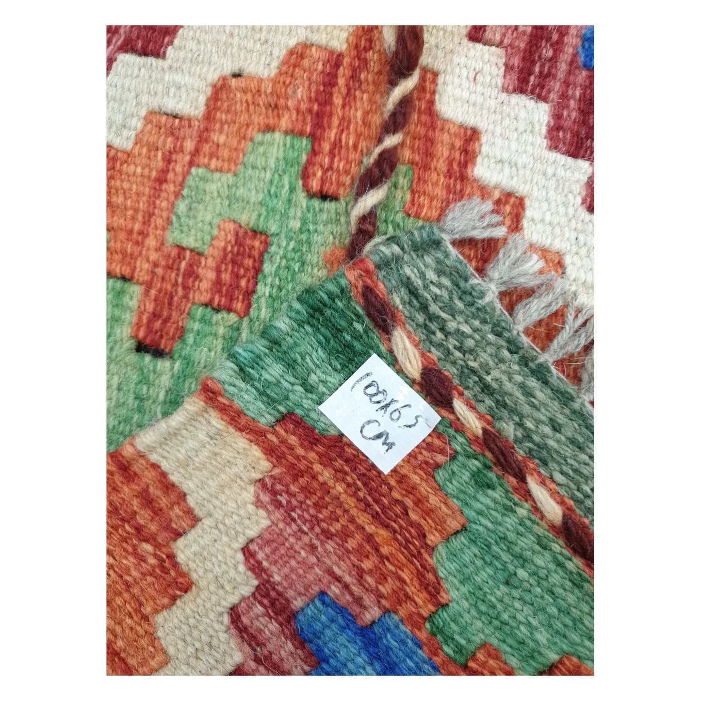 Close-up of Afghan Chobi Kilim wool flatweave texture, fringe, and geometric colour detail, 100 x 65 cm