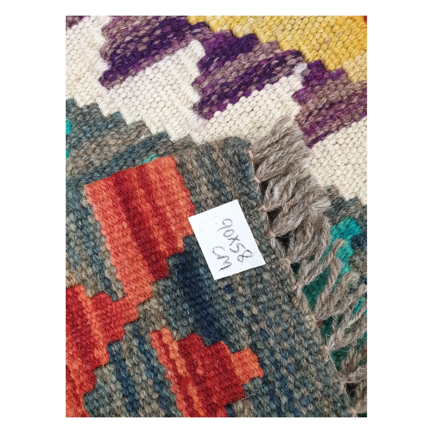 Close-up of Afghan Chobi Kilim wool flatweave texture, fringe, and geometric colour detail, 90 x 58 cm