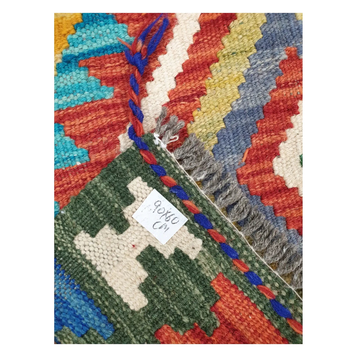 Close-up of Afghan Chobi Kilim wool flatweave texture, fringe, and geometric colour detail, 90 x 60 cm