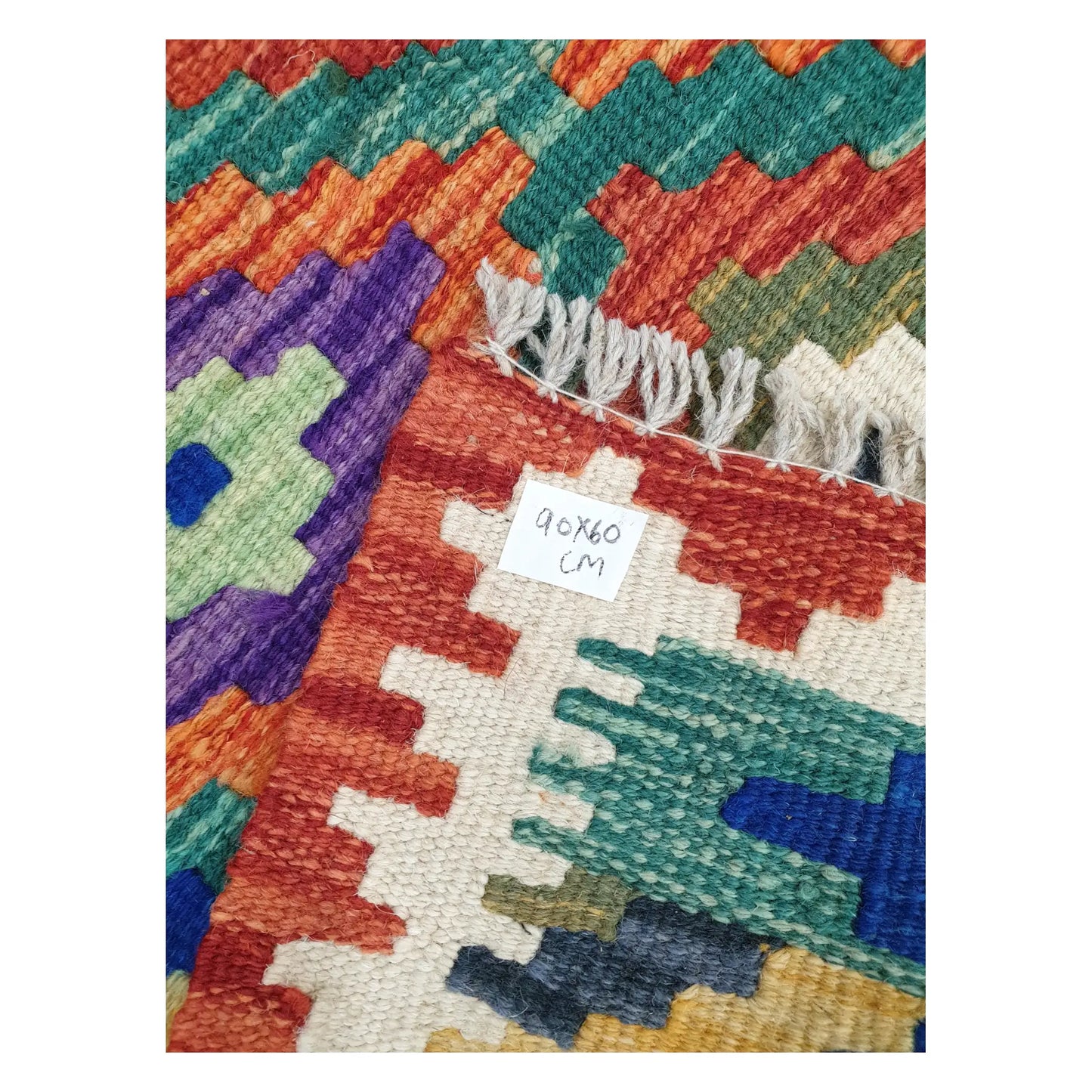 Close-up of Afghan Chobi Kilim wool flatweave texture, fringe, and geometric colour detail, 90 x 60 cm