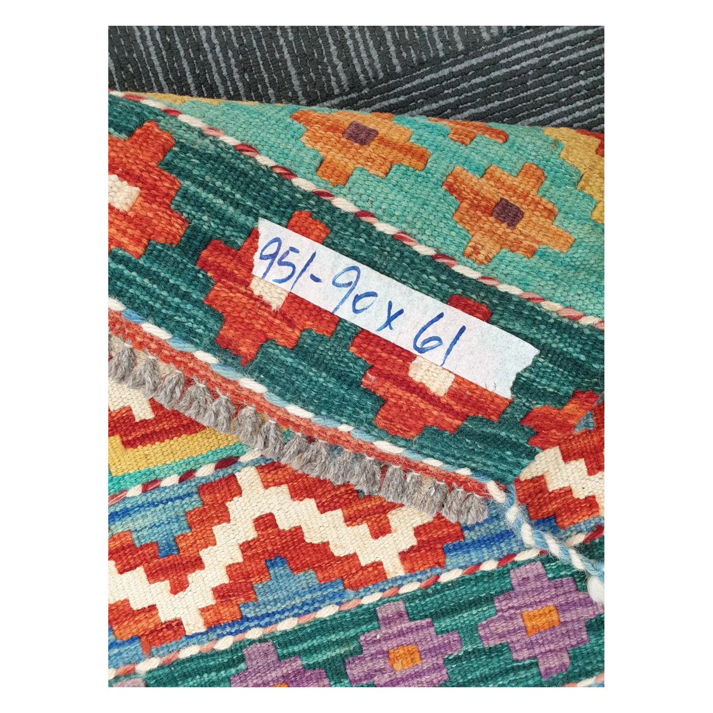 Close-up of Afghan Chobi Kilim wool flatweave texture, fringe, and geometric colour detail, 90 x 61 cm