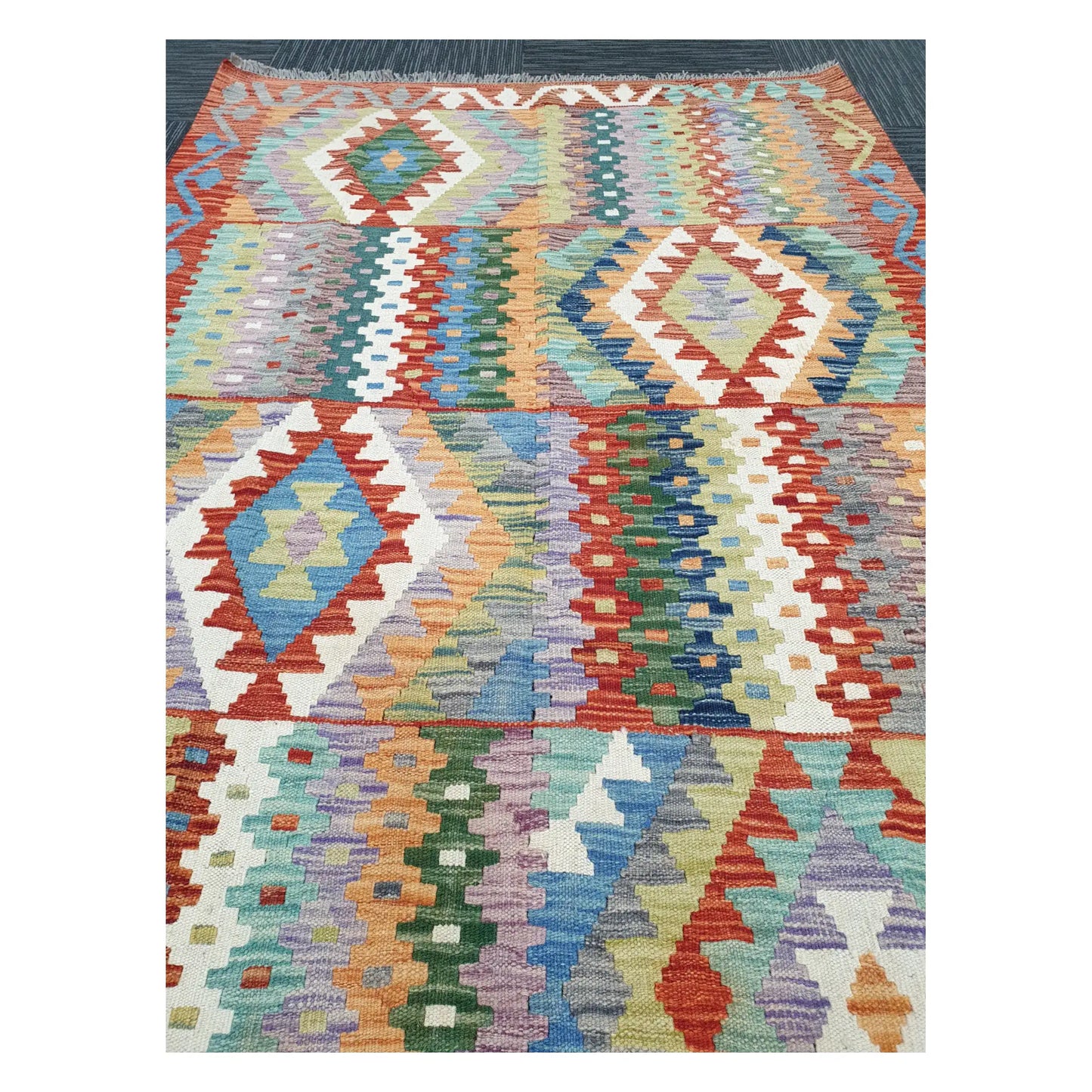 Close-up of Afghan Chobi Kilim rug with pastel diamond motifs in blue, sage, mint, ivory, and terracotta, 180 x 122 cm