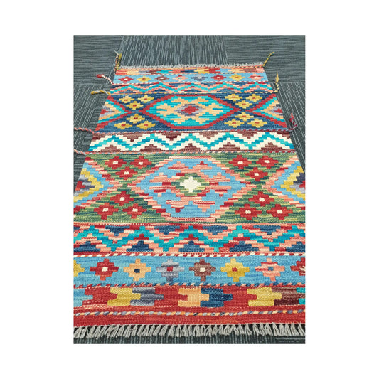 Angled view of Afghan Chobi Kilim rug showing bold geometric wool flatweave design, 96 x 62 cm