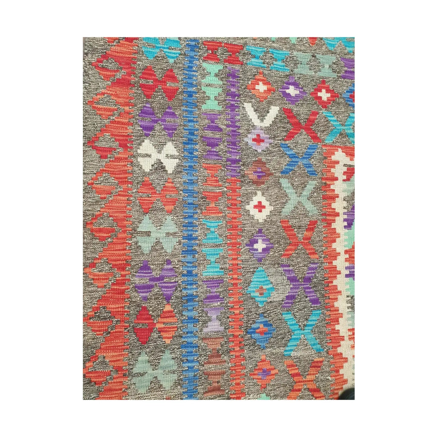 Side border detail of Afghan Chobi Kilim rug showing colourful flatweave pattern