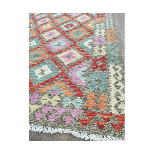 Border detail of Afghan Chobi Kilim pastel diamond rug showing fringe and woven motifs