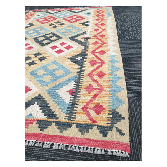 Angled detail of Afghan Chobi Kilim showing fringe, terracotta border, and flatweave geometric pattern, 144 x 100 cm