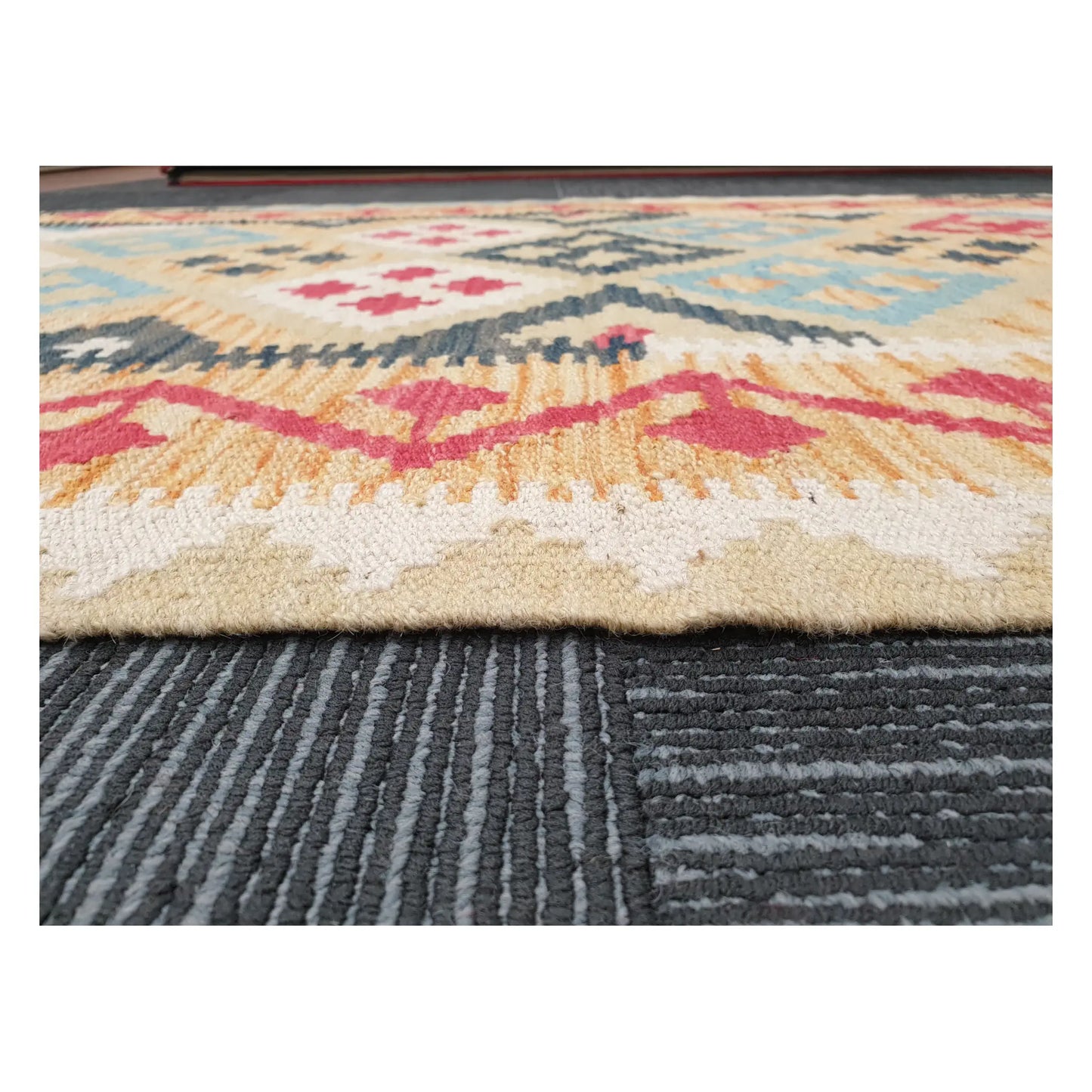 Low-angle close-up of Afghan Chobi Kilim showing wool flatweave texture and geometric border detail, 144 x 100 cm