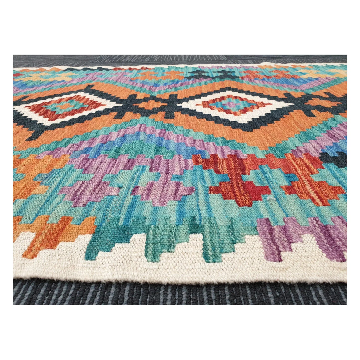 Low-angle close-up of Afghan Chobi Kilim wool flatweave texture and geometric pattern detail, 291 x 80 cm