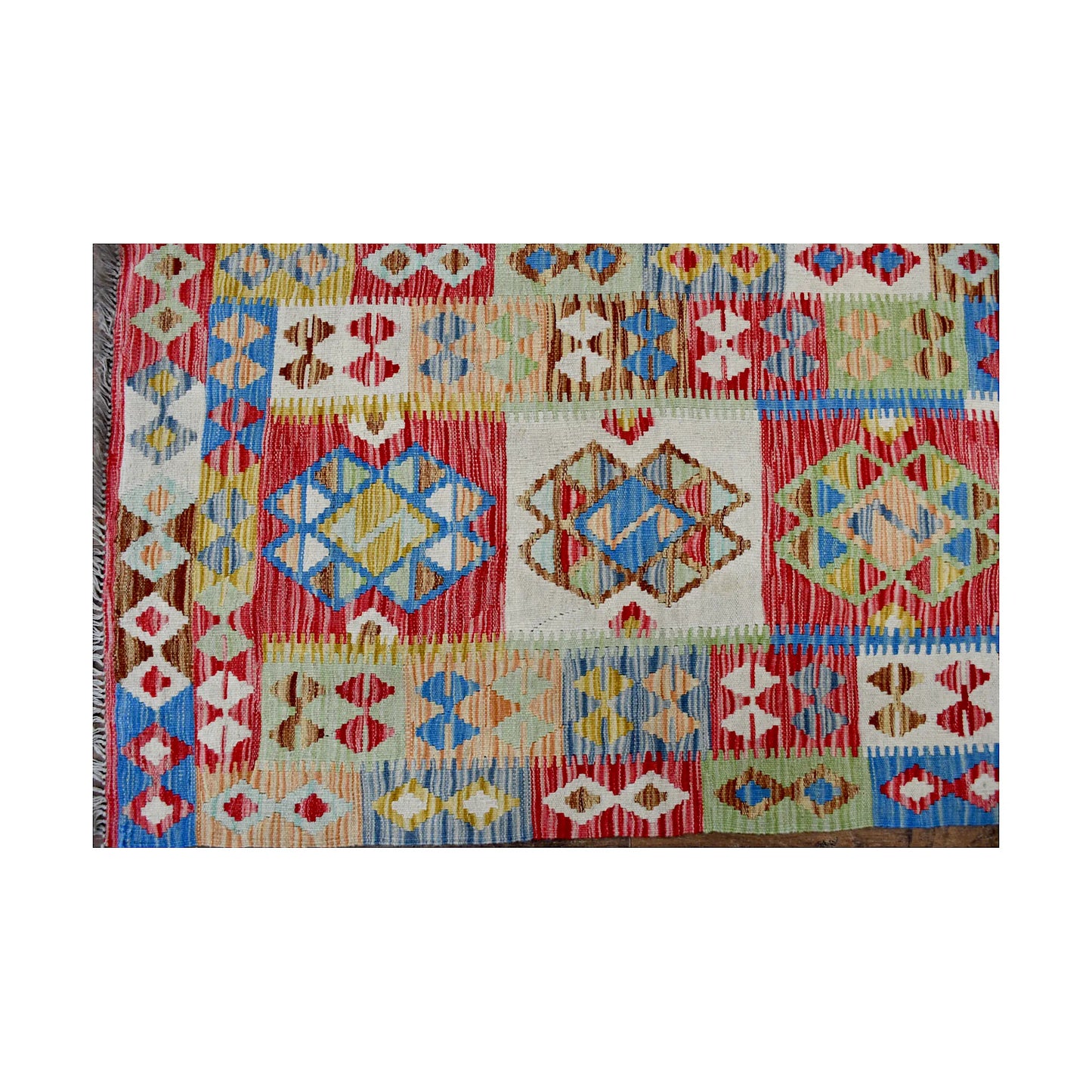 Close-up of Afghan Chobi Kilim runner showing multicolour geometric panels and woven flatweave detail
