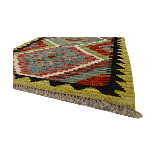 Angled fringe and flatweave detail of Afghan Chobi Kilim wool rug showing sage green, rust-orange, ivory and black geometric border