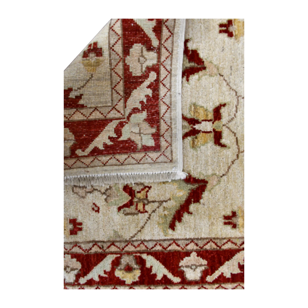 Folded-corner detail of Afghan Chobi runner showing the reverse weave beside its beige floral front and red border