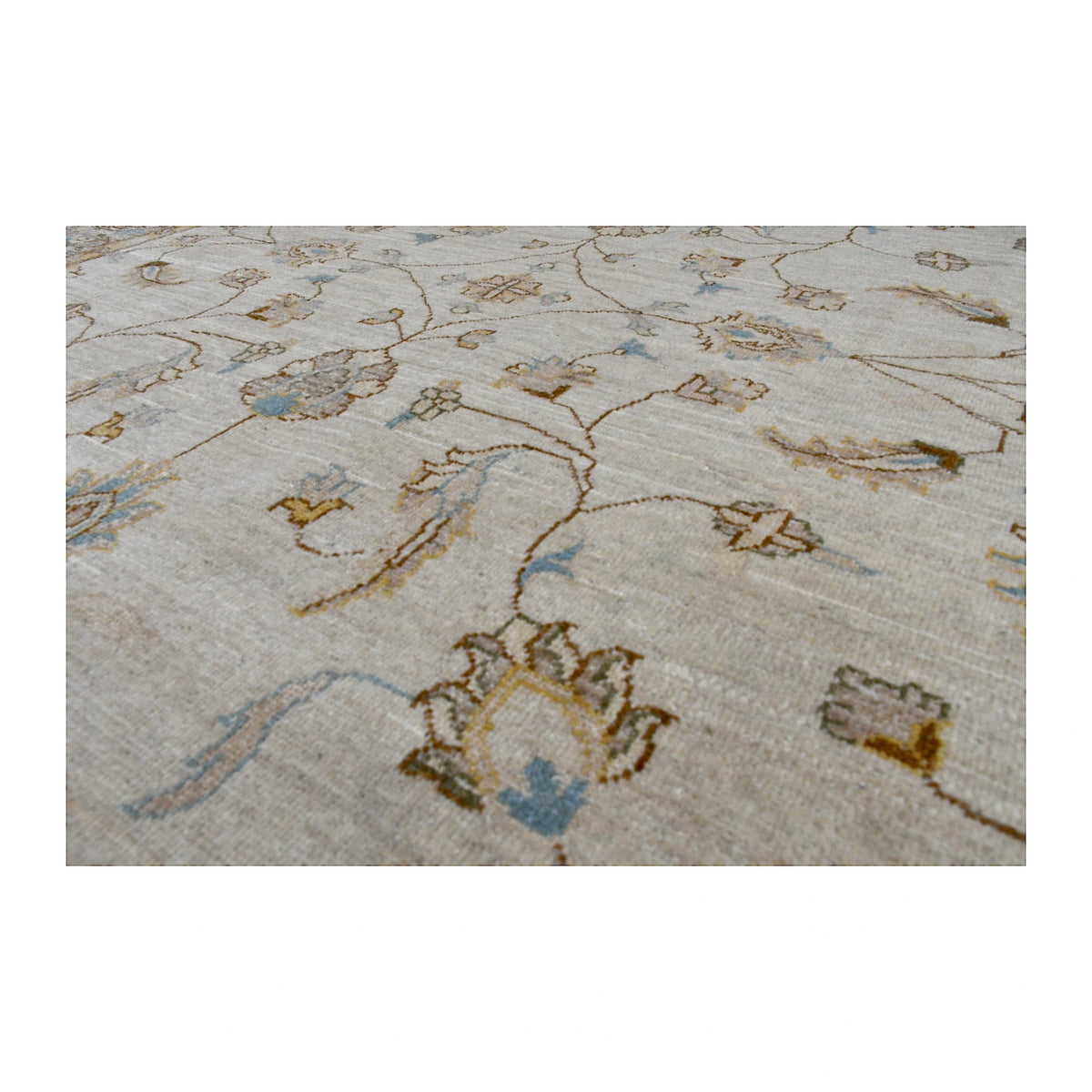 Angled close-up of Afghan Chobi soft beige rug showing the hand-knotted wool pile and delicate floral motifs in blue, gold and brown