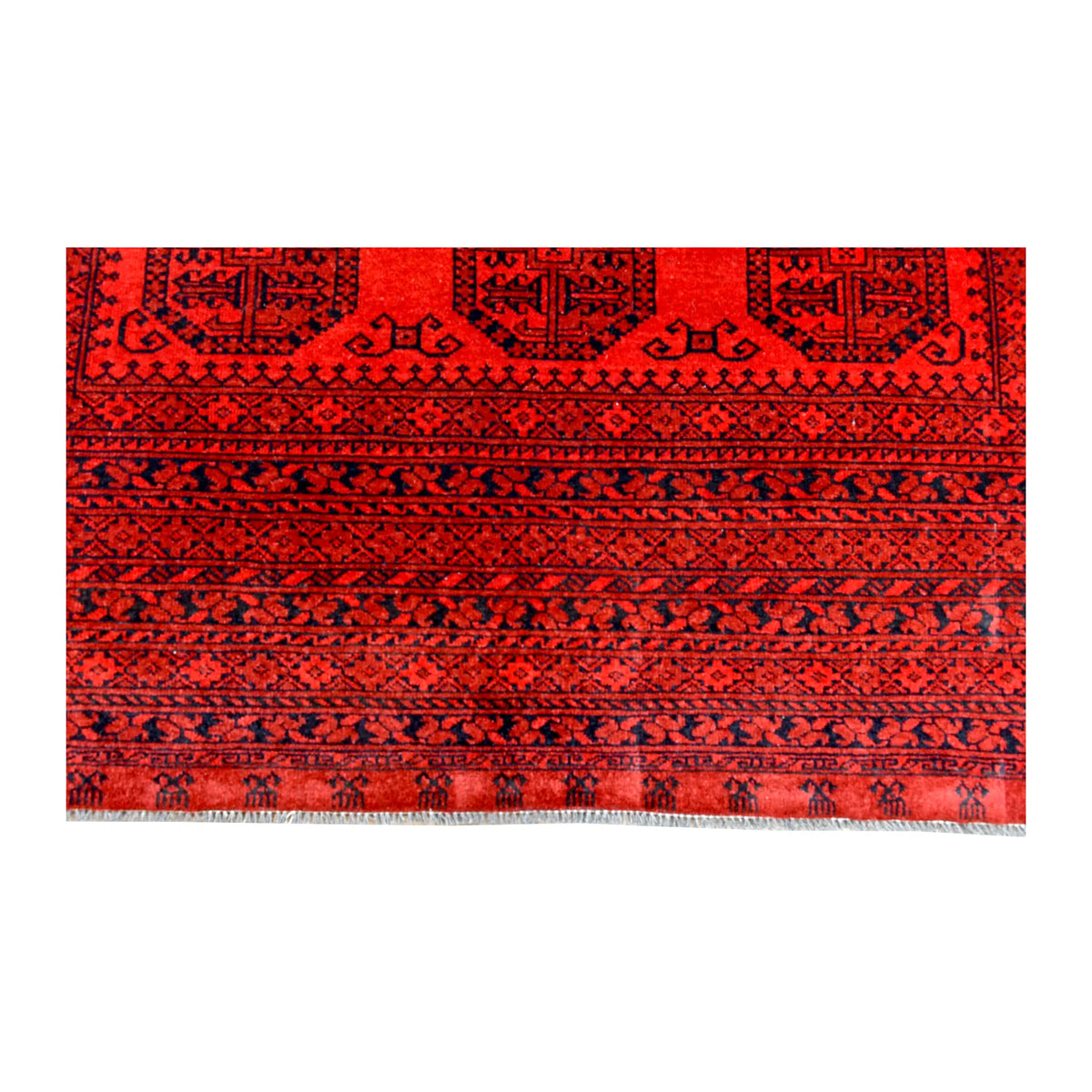 End-border detail of Afghan Ersari rug showing repeated geometric bands in deep red, burgundy, terracotta and charcoal