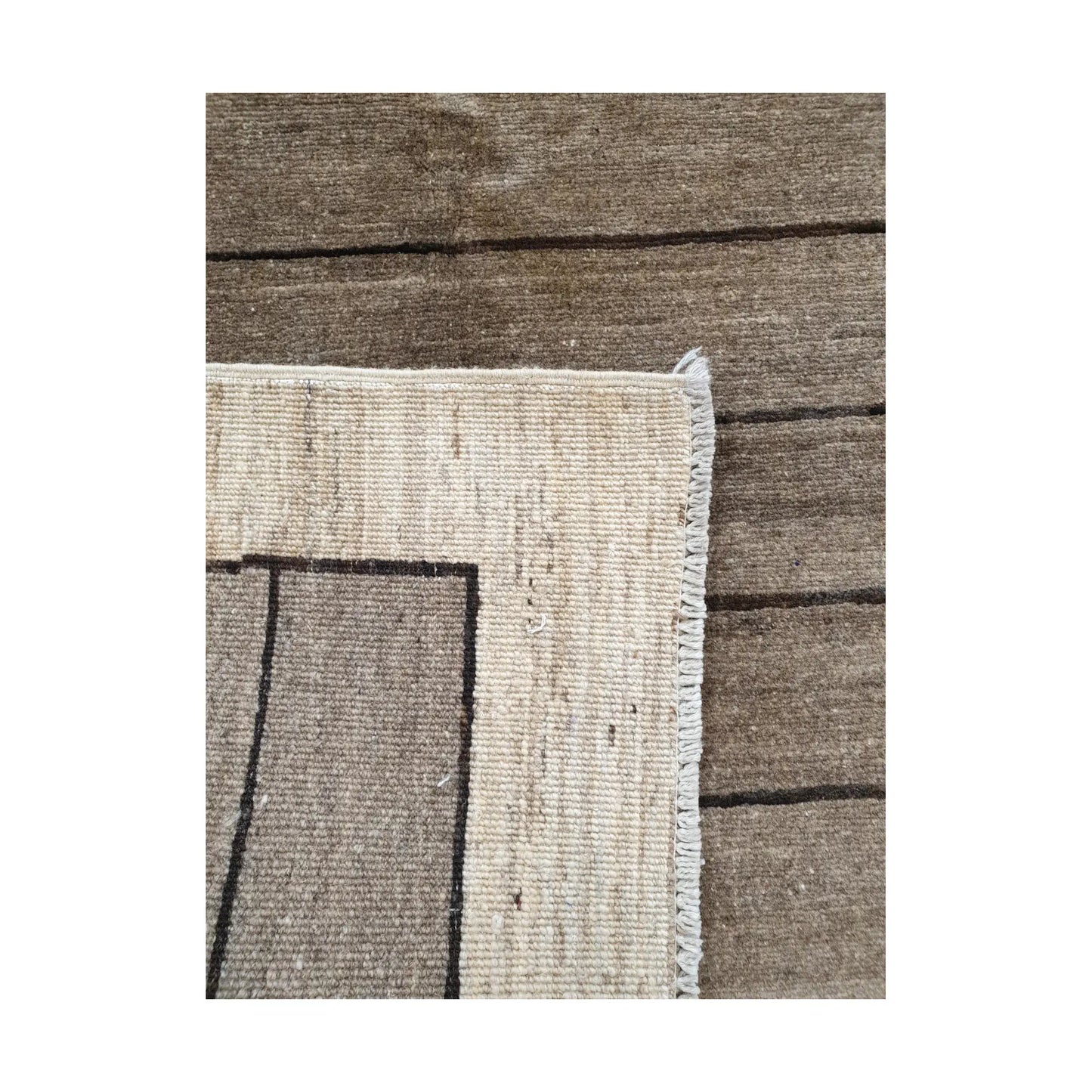Back corner detail of Afghan Gabbeh hand-knotted wool rug showing reverse weave, cream border and natural wool structure, 166 x 106 cm