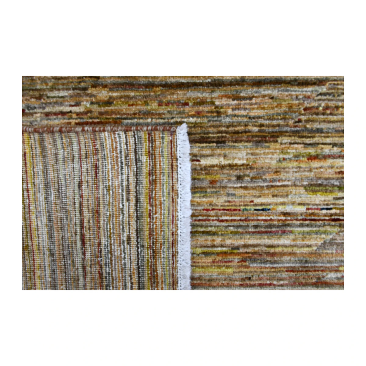 Folded-corner detail of Afghan Gabbeh rug showing the reverse weave, striped front and pale fringe