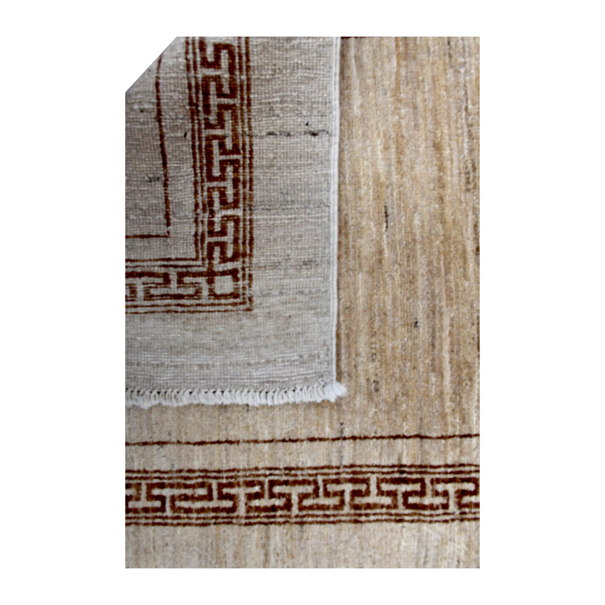 Folded-corner detail of Afghan Gabbeh runner showing the pale reverse weave beside its beige front and brown geometric border