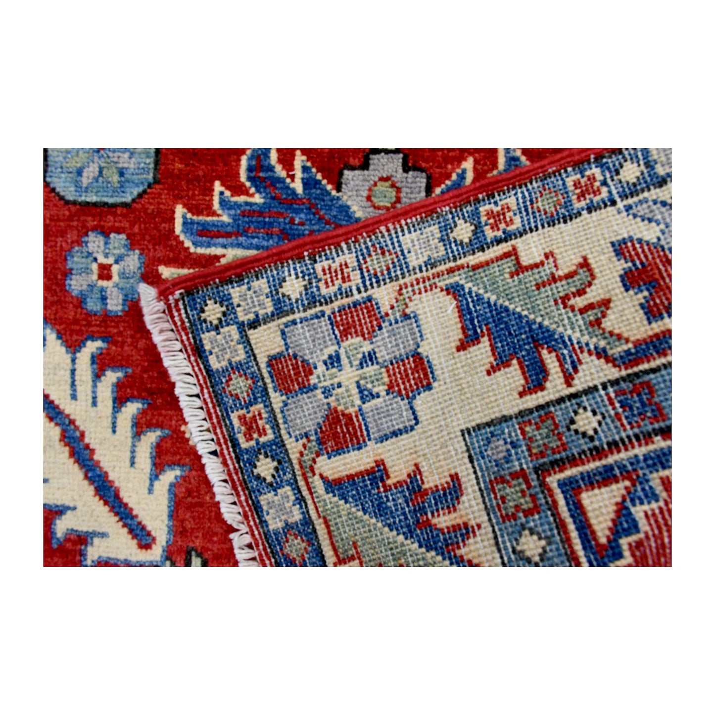Folded corner reverse-weave detail of Afghan Kazak hand-knotted wool rug showing the back structure, pattern and weave