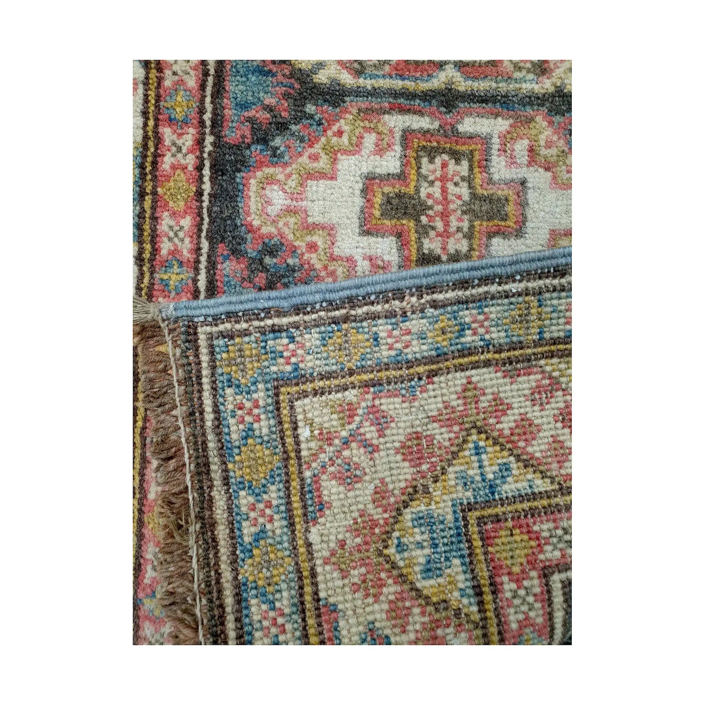 Folded corner reverse-weave detail of Afghan Kazak hand-knotted wool rug showing back structure, border pattern and weave