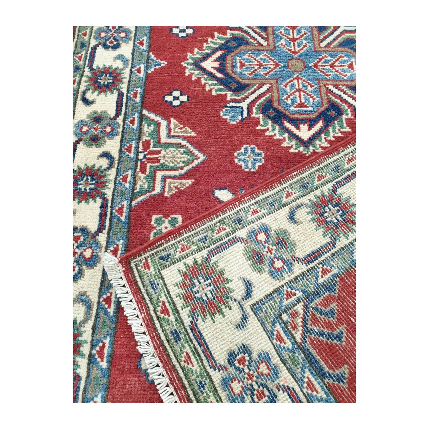 Close-up of Afghan Kazak wool runner rug corner medallion and border detail