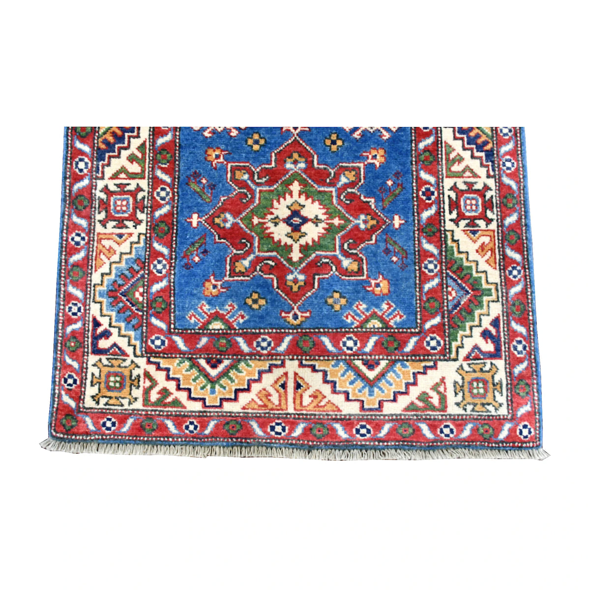 Fringe-end detail of Afghan Kazak runner showing a red geometric medallion, angular ivory border and pale fringe