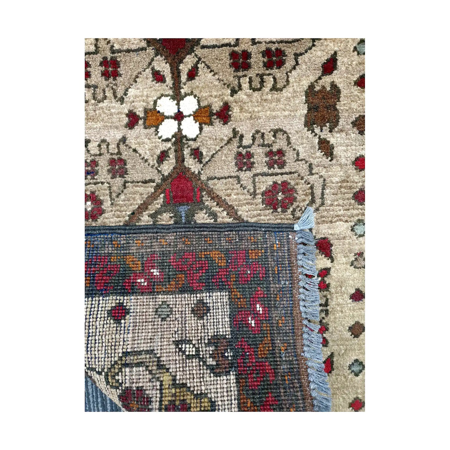 Folded corner reverse-weave detail of Afghan Khal Mohammadi hand-knotted wool rug showing back structure, fringe, border pattern and weave