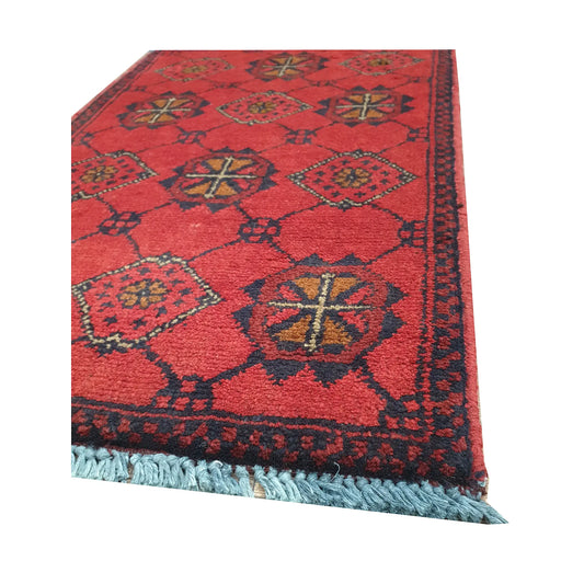 Angled fringe and border detail of Afghan Khal Mohammadi red wool rug showing navy edging and floral motifs