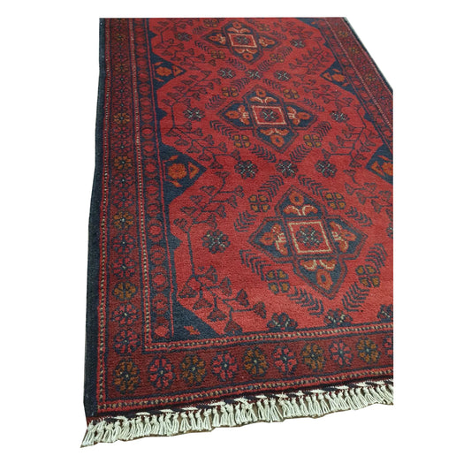 Close-up of Afghan Khal Mohammadi rug showing red geometric pattern and fringe detail