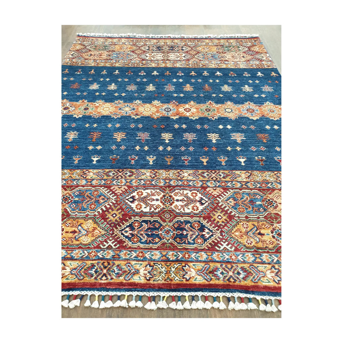 Field and border detail of Afghan Khurjeen hand-knotted rug with patterned bands