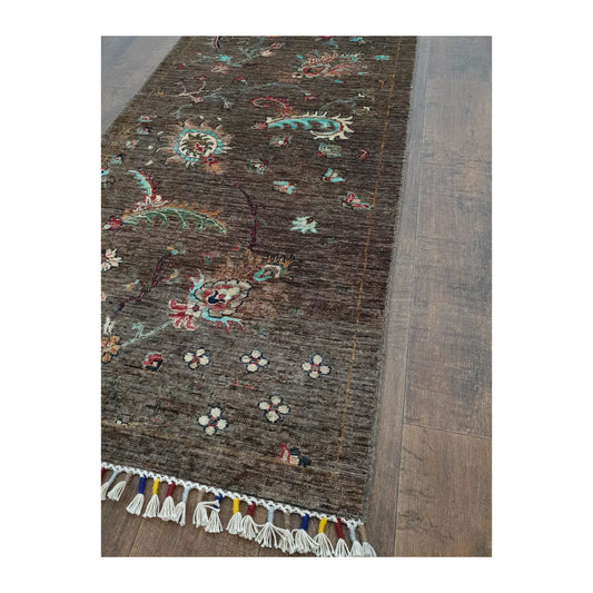 Fringe and field detail of Afghan Khurjeen wool runner rug with botanical pattern