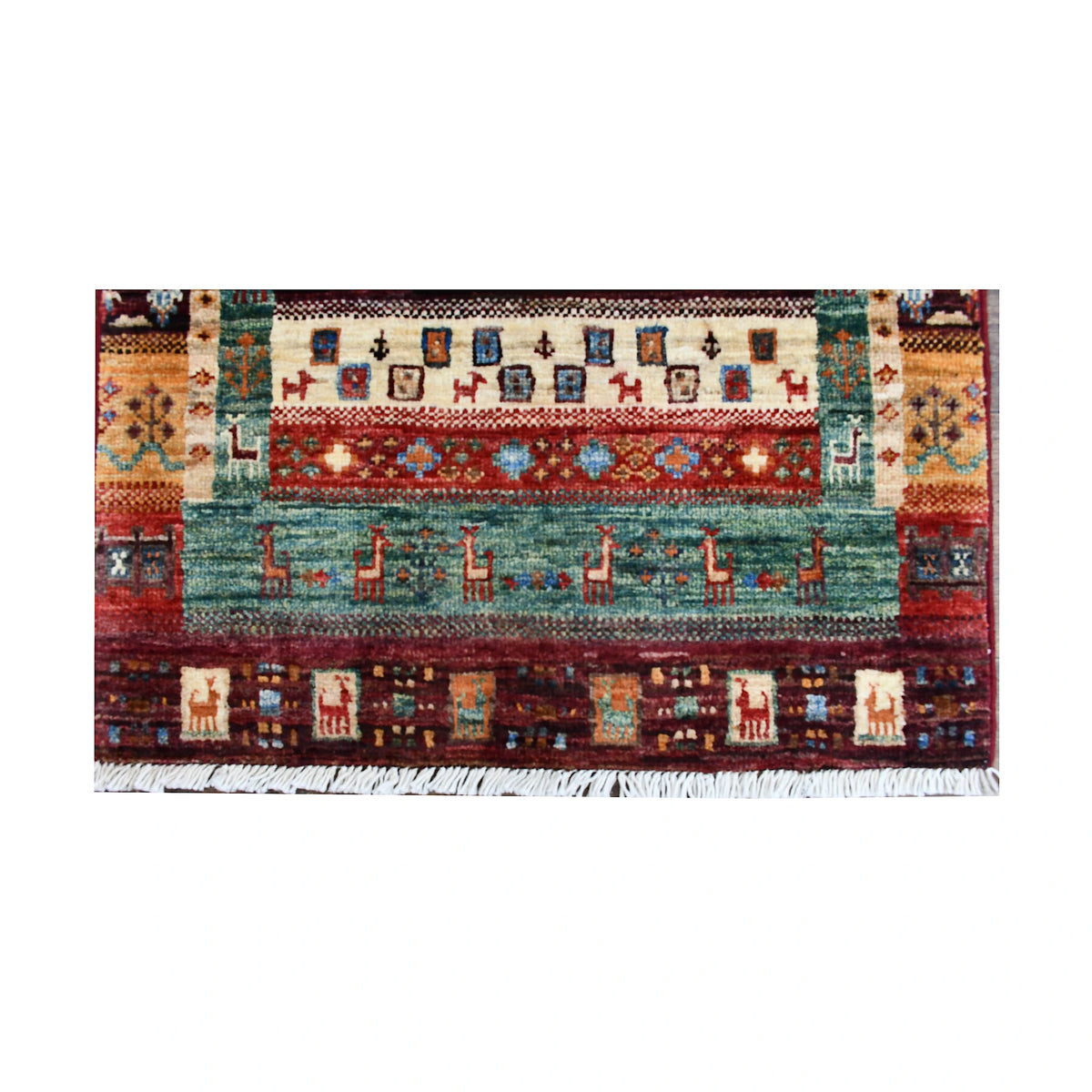 End panel and fringe detail of Afghan Khurjeen rug with teal field, burgundy border and ivory geometric motifs
