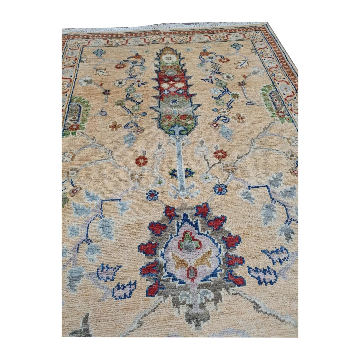 Close-up of Afghan Khurjeen wool runner rug showing floral medallion details, muted blue vines and warm red accents