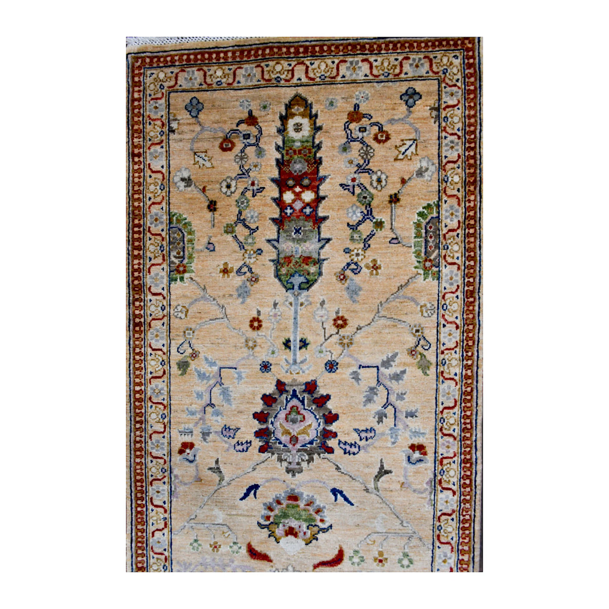 Close-up of an elongated floral-geometric motif with muted blue, rust and brown details on the Khurjeen runner
