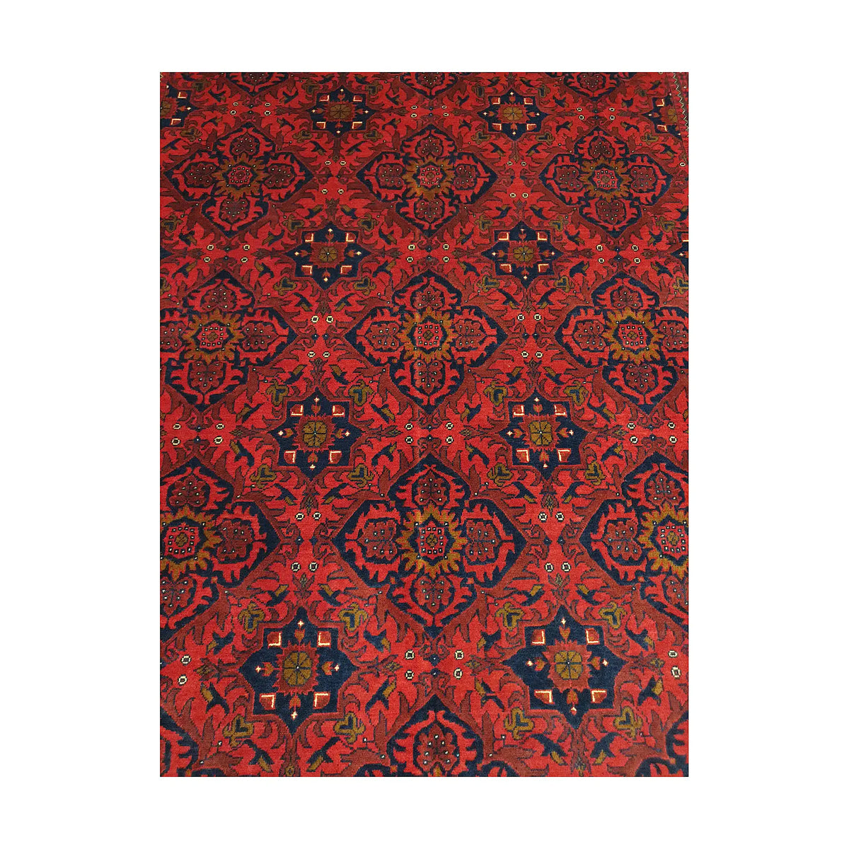 Close-up of Afghan Kunduz rug showing deep red floral lattice with navy, blue, ivory and charcoal details