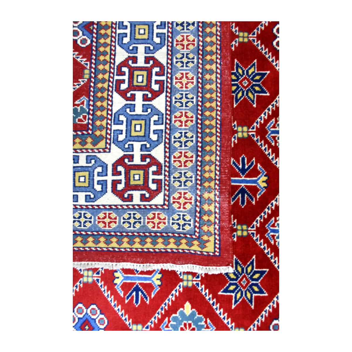 Folded-corner detail of Afghan Shirvan rug showing the reverse weave beside the red geometric front and patterned border