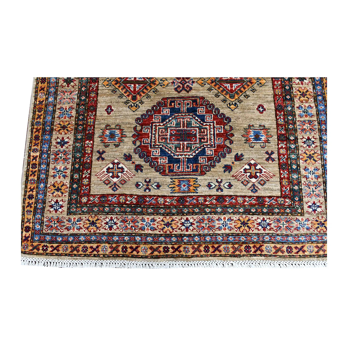 Fringe and end-border detail of Super Kazak rug with a geometric medallion and layered navy, rust and ochre bands