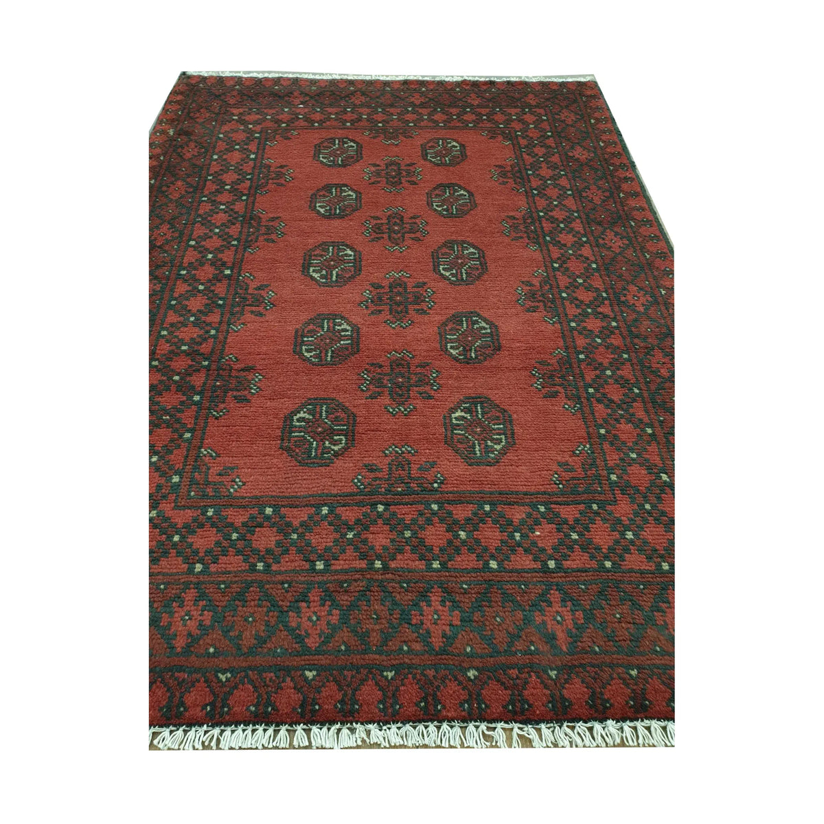 Angled full view of Afghan Turkoman wool rug showing red field, black border and cream geometric details
