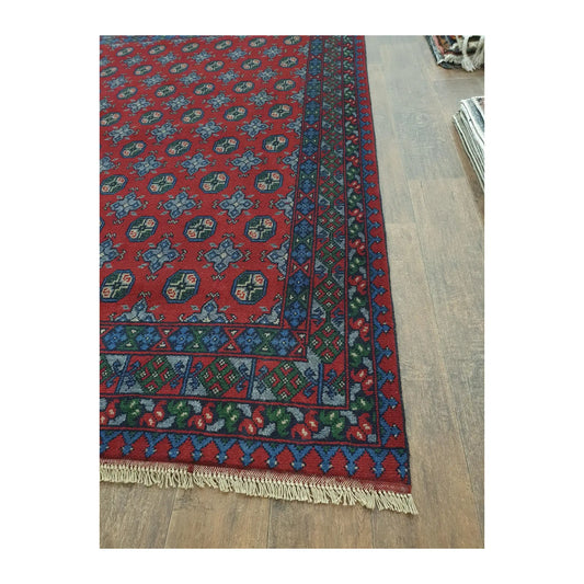 Border and fringe detail of Afghan Turkoman wool rug with blue geometric pattern