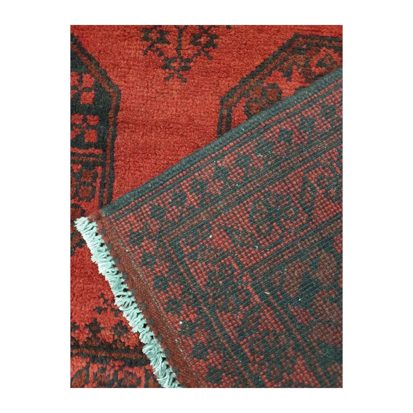Reverse-weave and fringe detail of Afghan Turkoman wool rug showing back structure and hand-knotted pattern