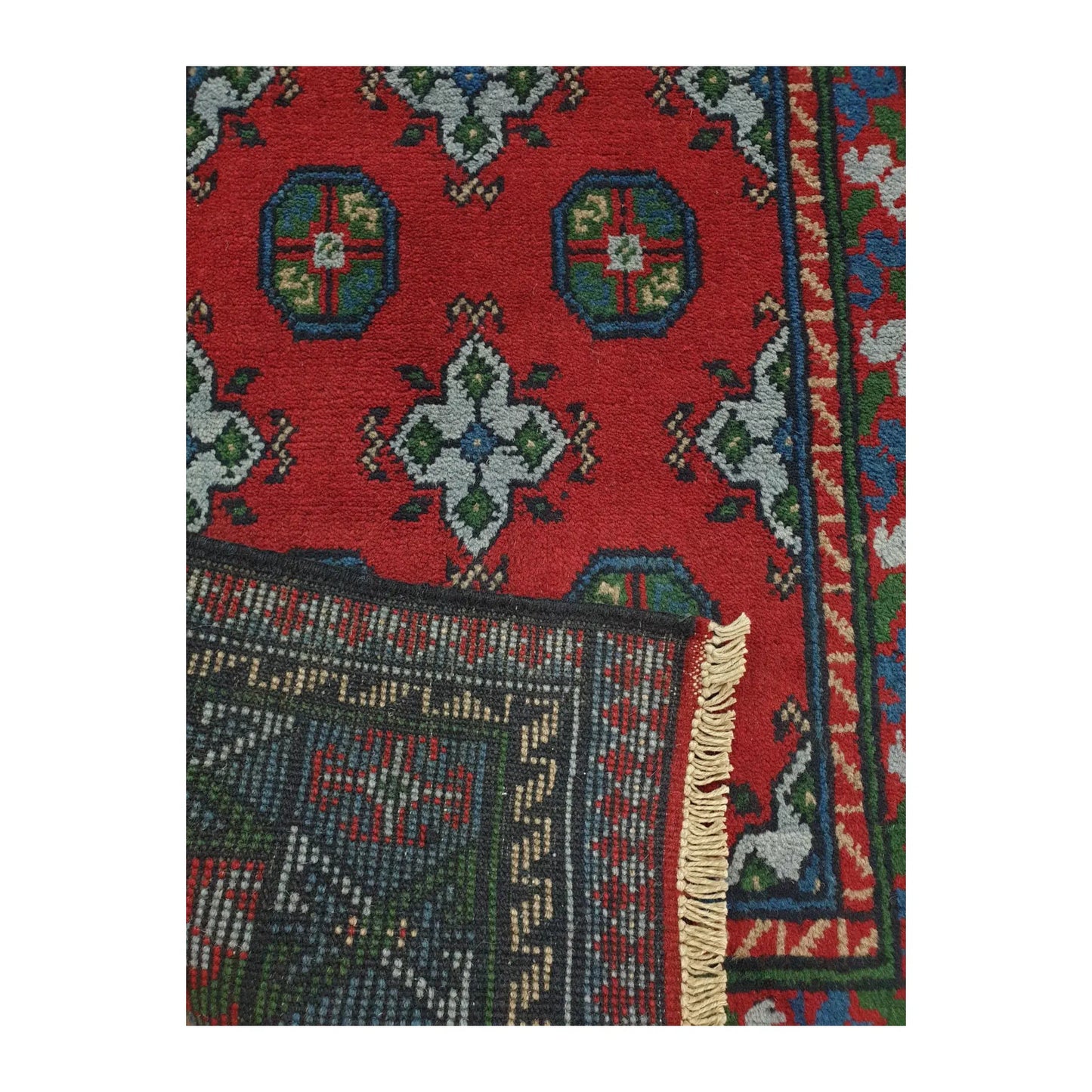 Reverse weave detail of Afghan Turkoman hand-knotted wool runner rug showing back construction and edge finish