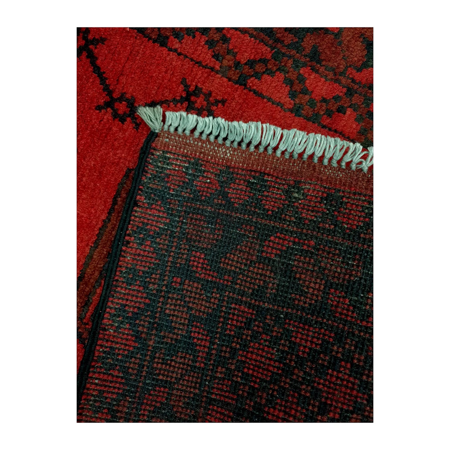 Reverse-weave and fringe detail of Afghan Turkoman wool runner rug showing back structure and hand-knotted pattern