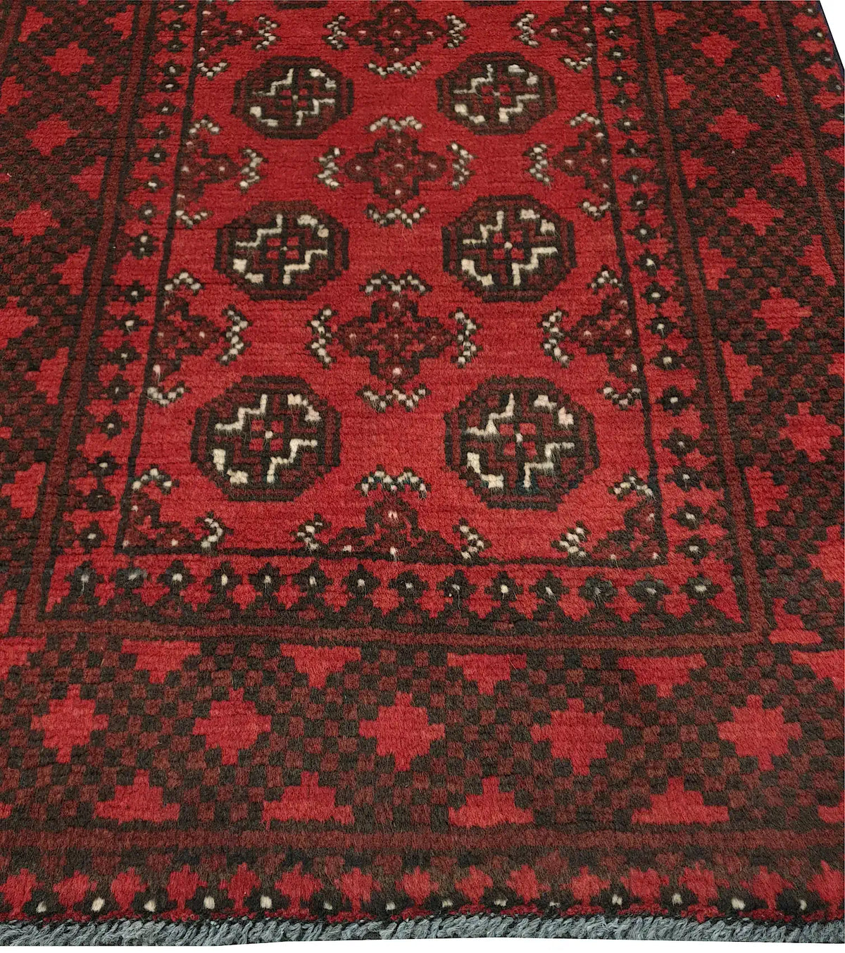 End field and border detail of Afghan Turkoman rug with repeated gul medallions and red-black tribal pattern