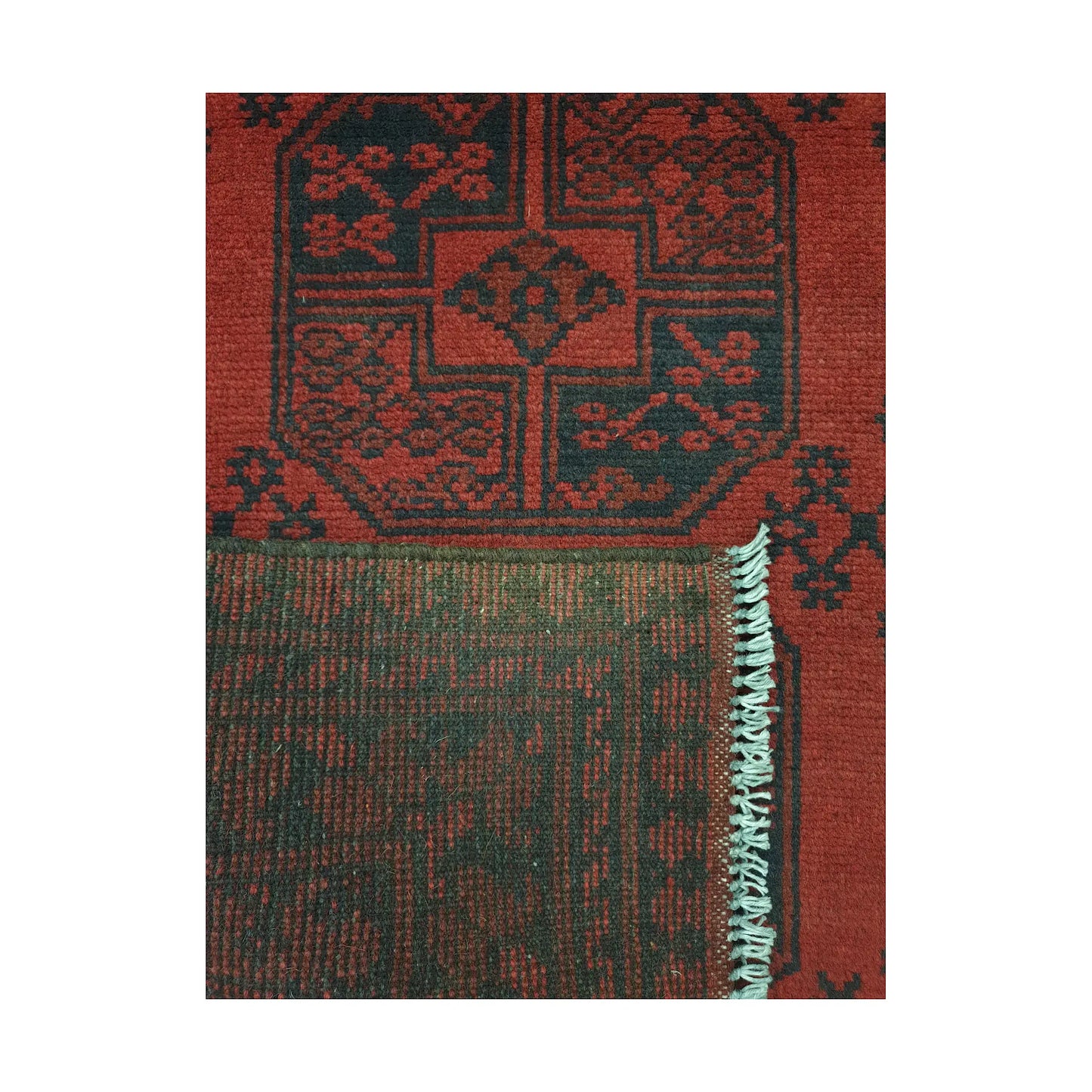 Folded corner detail of Afghan Turkoman rug showing the back of the rug and red front pattern
