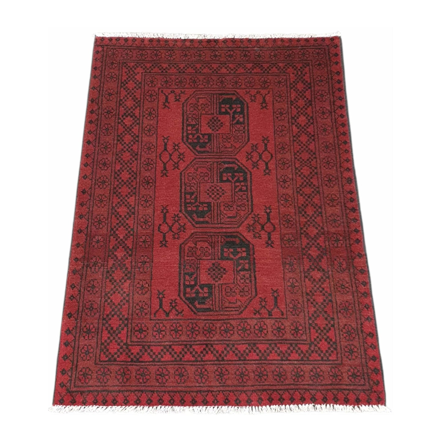 Angled view of Afghan Turkoman wool rug with red field and three gul-style medallions, 144 x 102 cm
