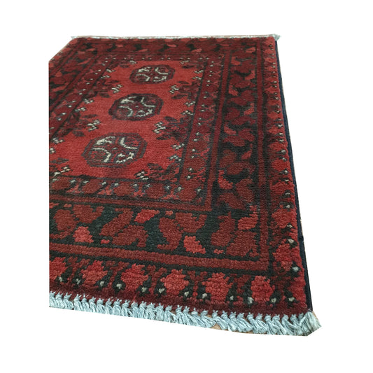 Angled fringe and border detail of Afghan Turkoman wool rug showing layered dark brown and red tribal motifs