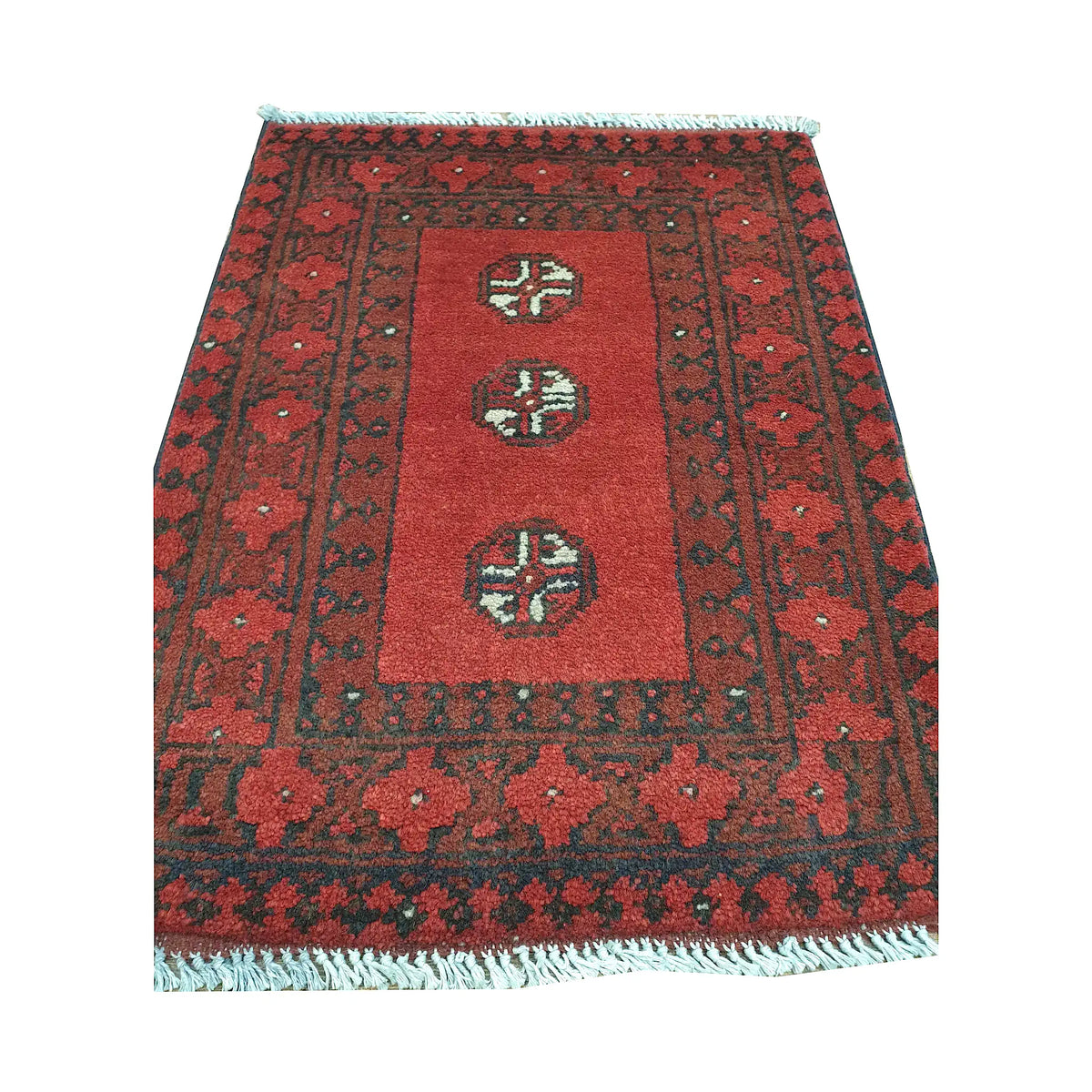 Afghan Turkoman wool rug front detail showing three spaced quartered guls within an open red field