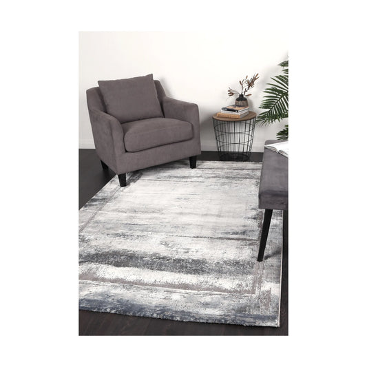 Antep 23314 Grey modern rug styled with chair and indoor décor, showing soft white grey tonal pattern, 230 x 160 cm