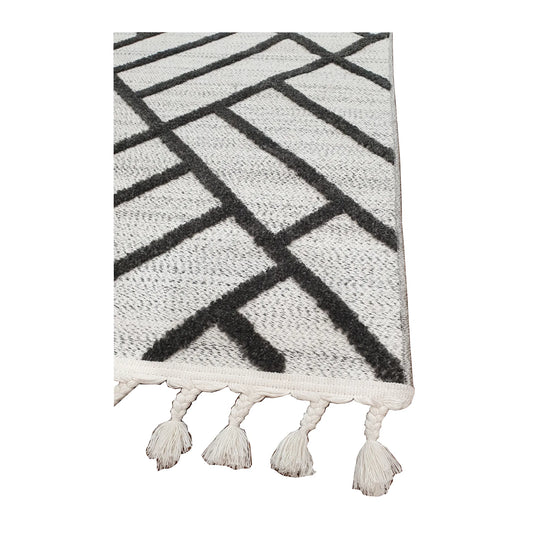 Tassel edge detail of Archer runner rug showing ivory textured surface and black geometric design