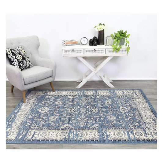 Arya blue traditional floral rug styled with white furniture in a neutral setting